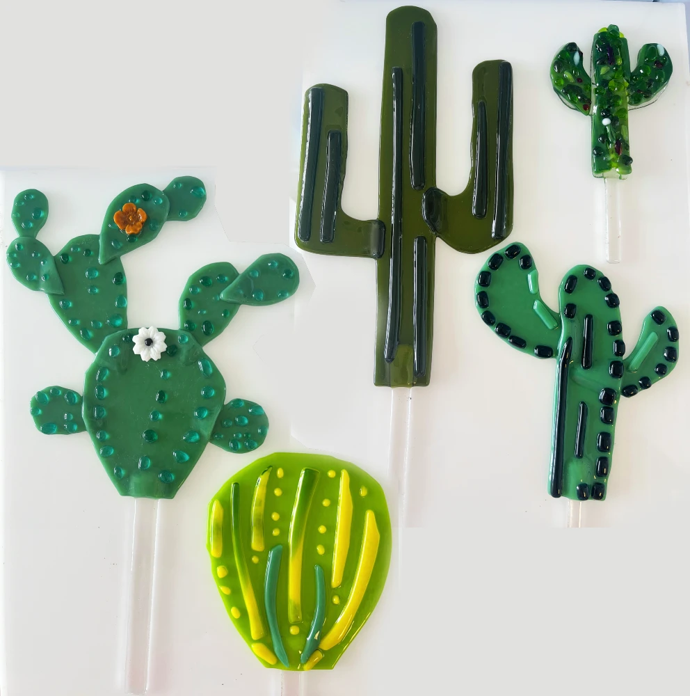 Five decorative plant stakes in the shape of various cactus plants made at Glass Duchess Studio, Port Charlotte FL